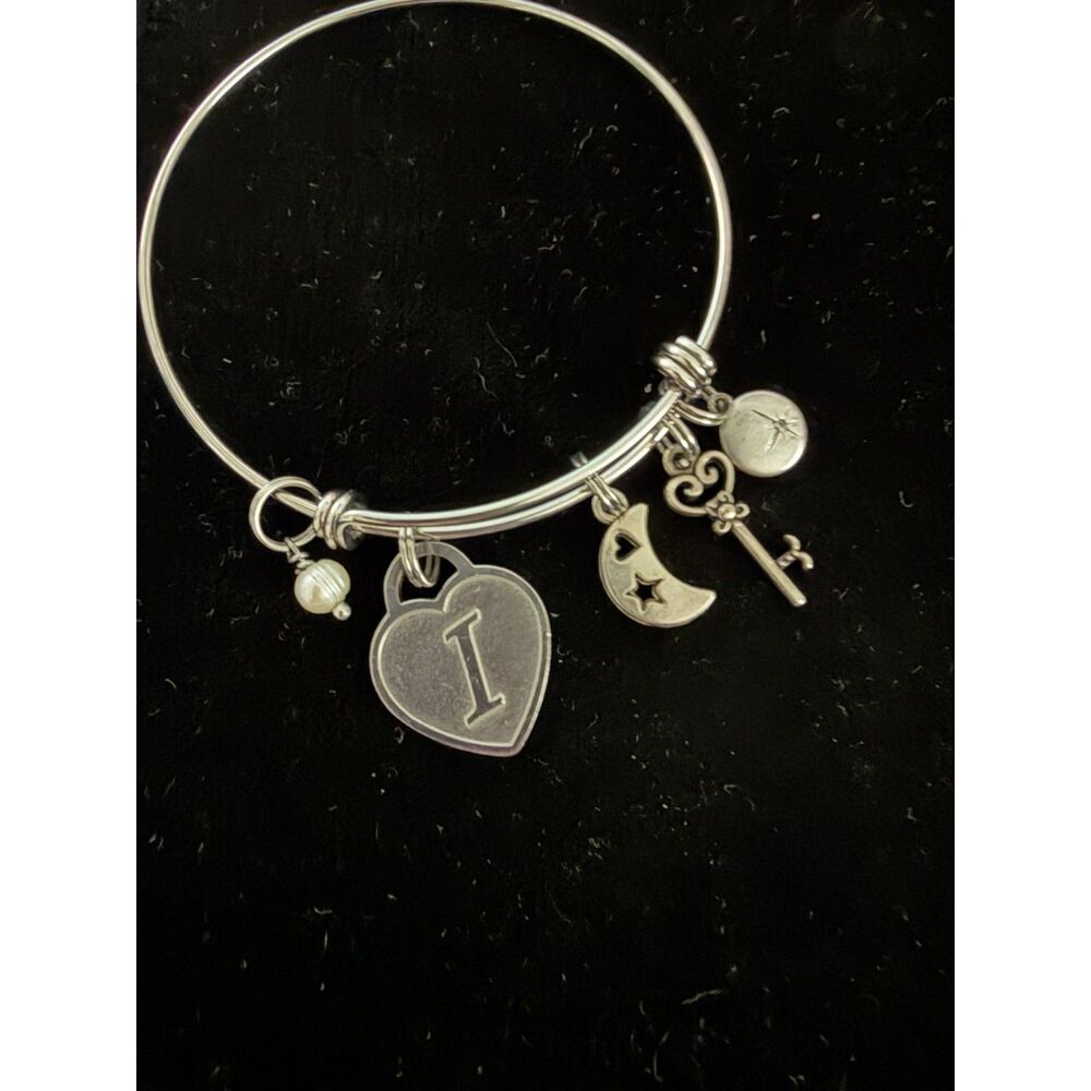 Silver tone charm bracelet with heart, moon, key and pearl charms with letter I